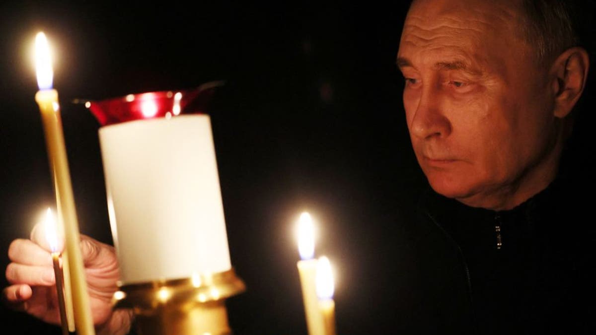 Putin at church service for those killed in terror attack.