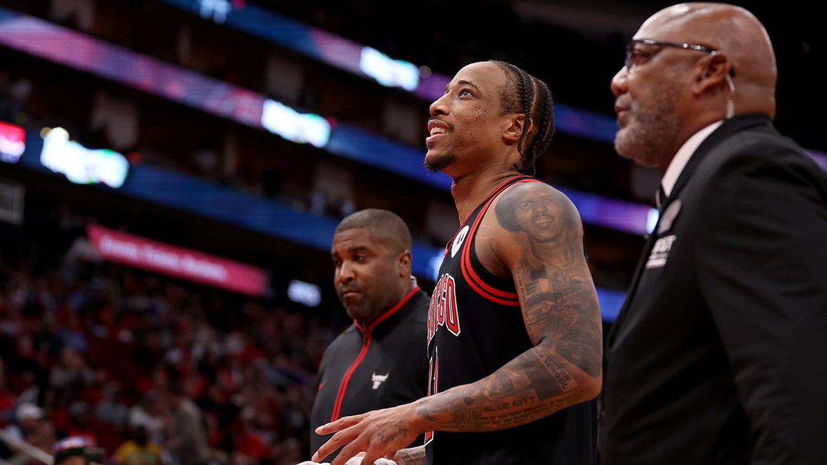 DeRozan being escorted away from the court