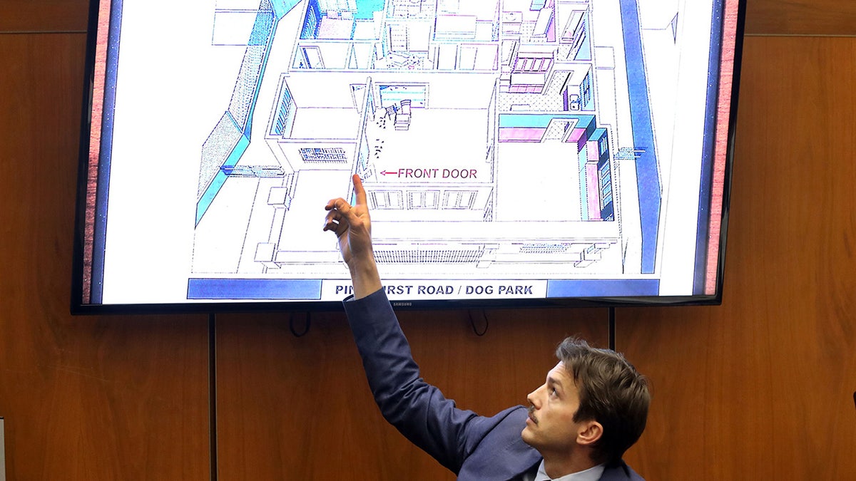 Ashton Kutcher pointing to an apartment blueprint in court