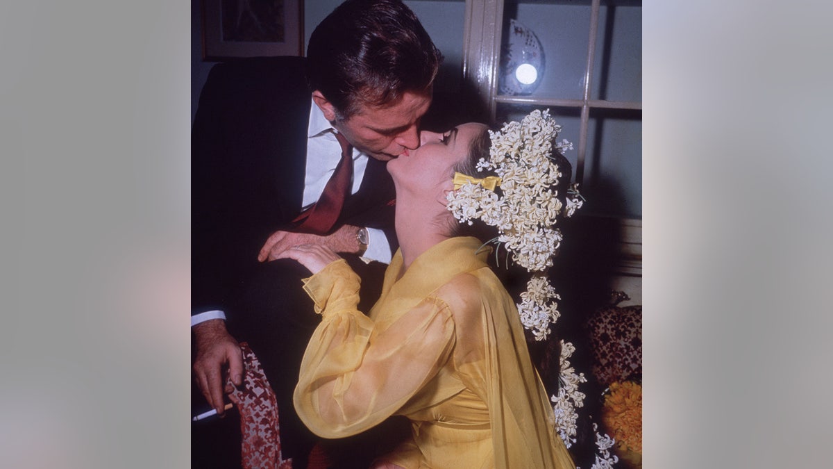 Elizabeth Taylor and Richard Burton kissing on their wedding day