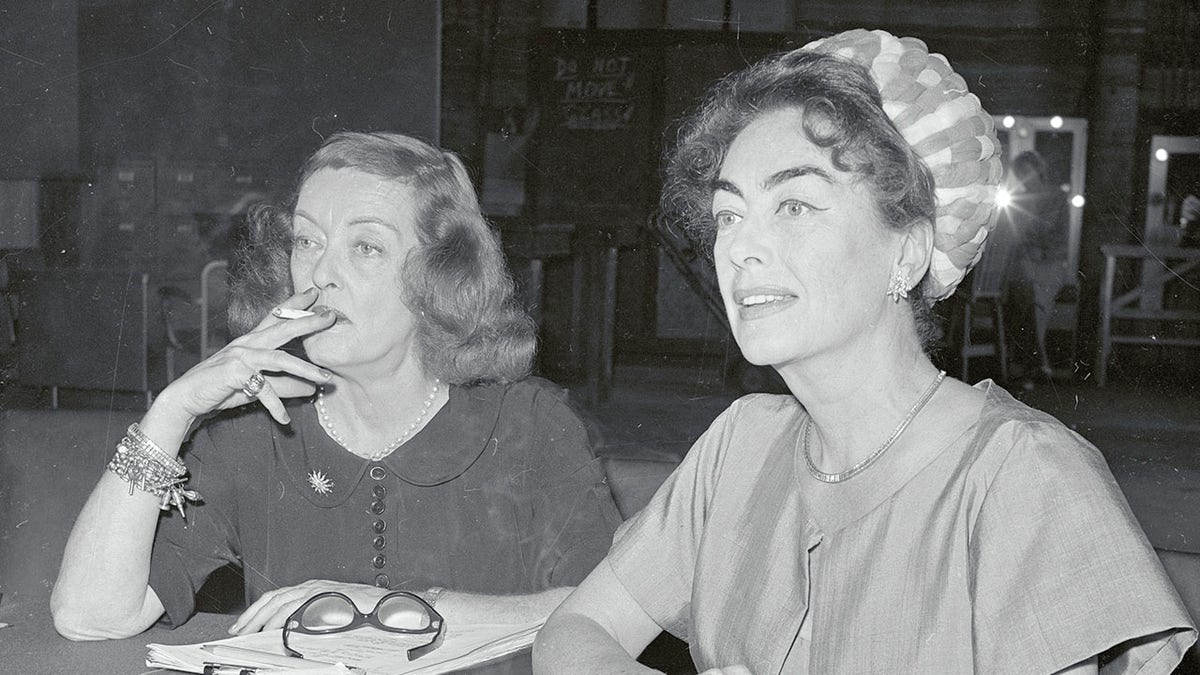 Bette Davis and Joan Crawford sitting together