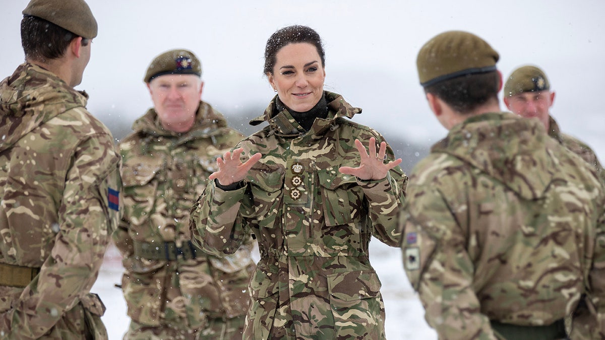 Kate Middleton wearing army gear as she interacts with guards