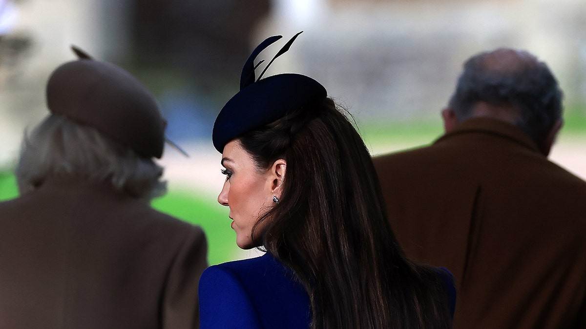 Kate Middleton with her back turned looking to the side