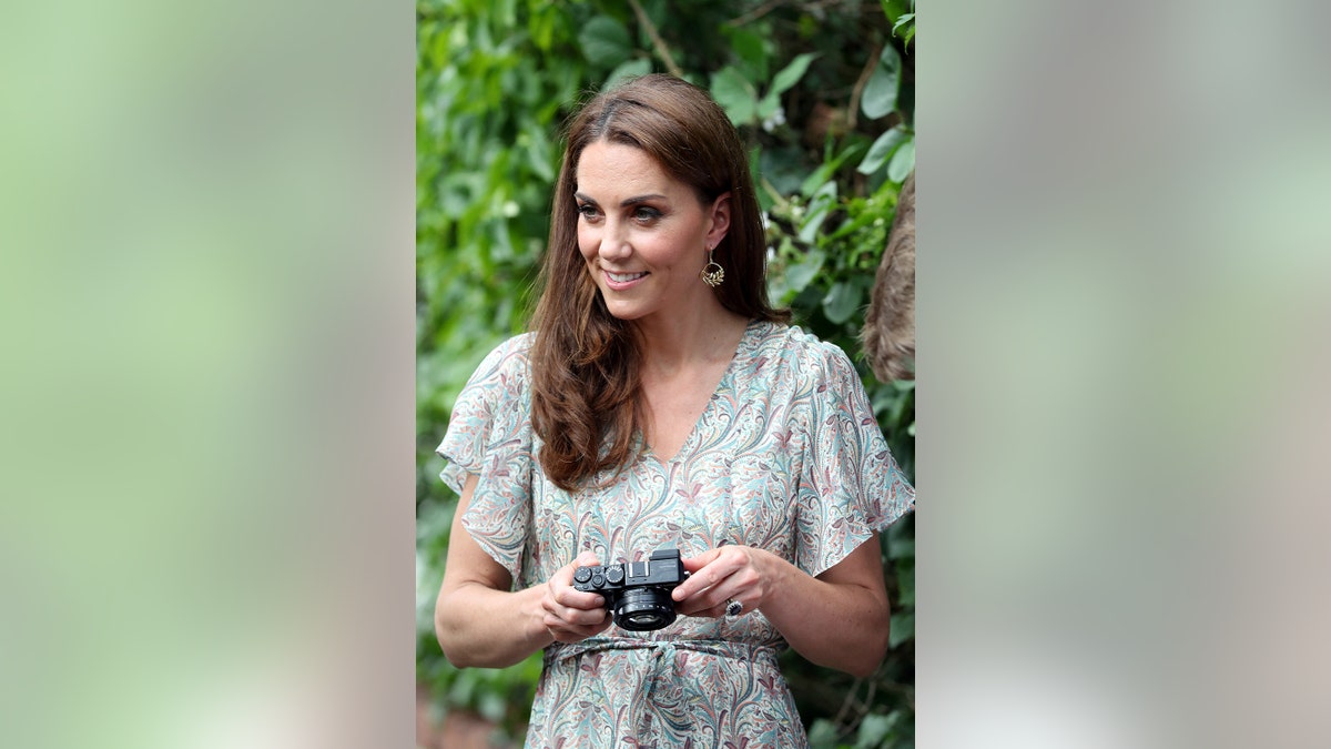 Kate Middleton holding onto a camera