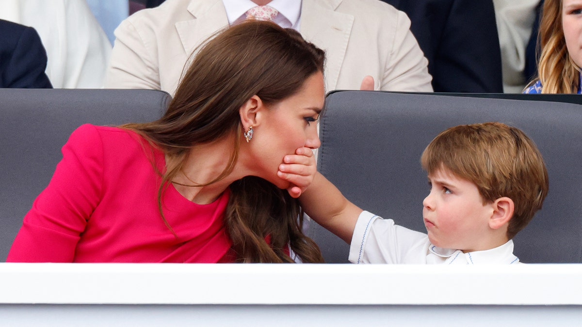 Prince Louis covering Kate Middletons mouth