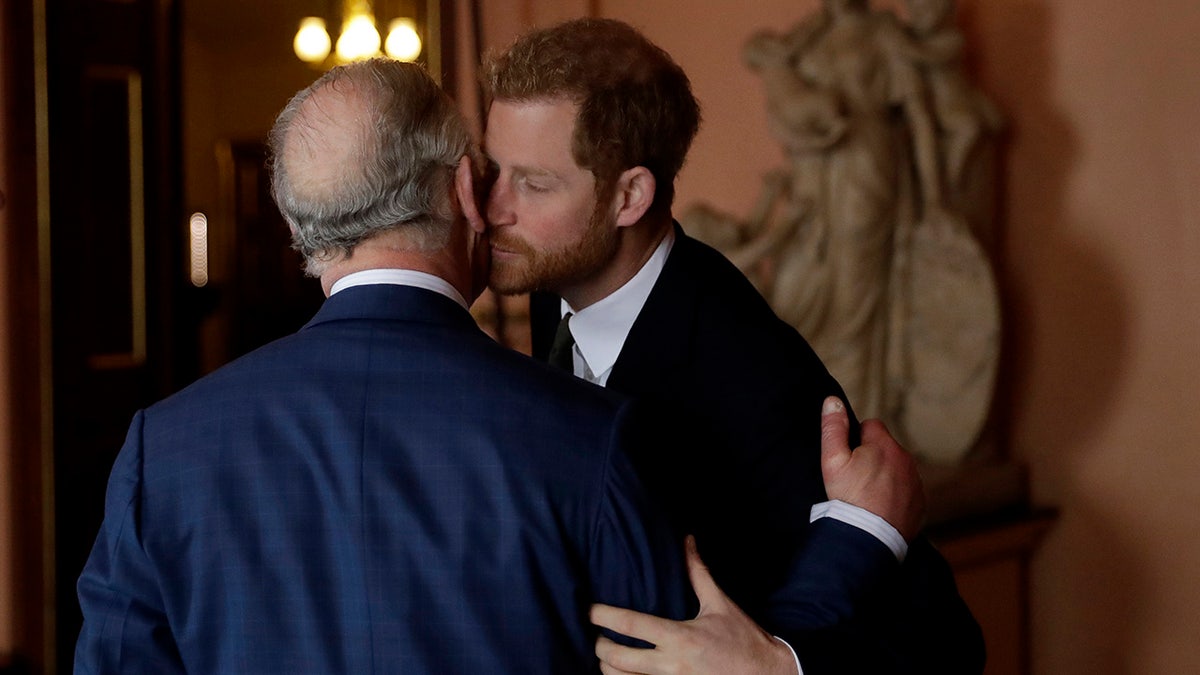Prince Harry kissing his father on the cheek