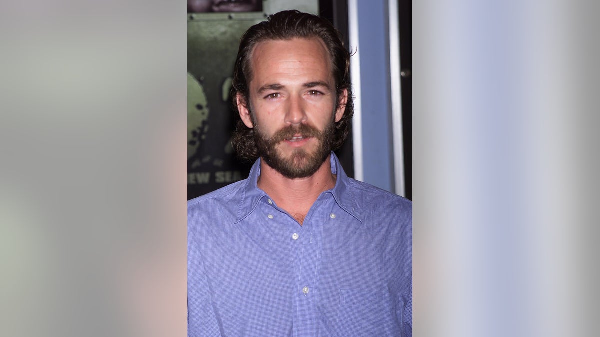 A close-up of Luke Perry in a light blue shirt