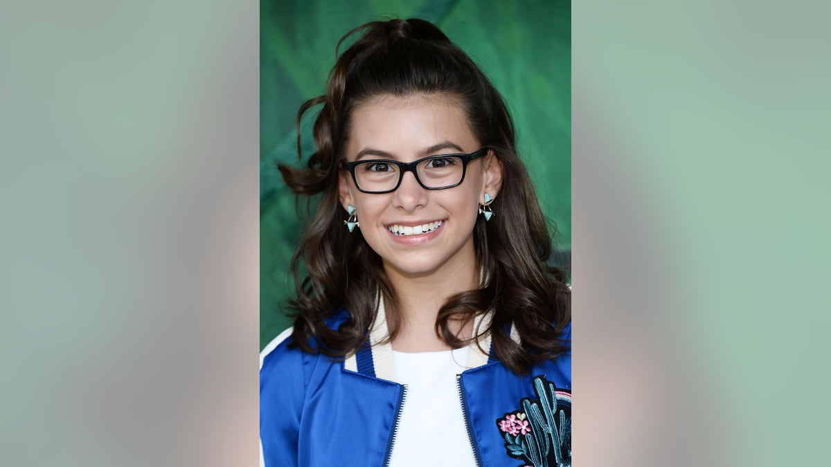 A close-up of a young Madisyn Shipman with glasses