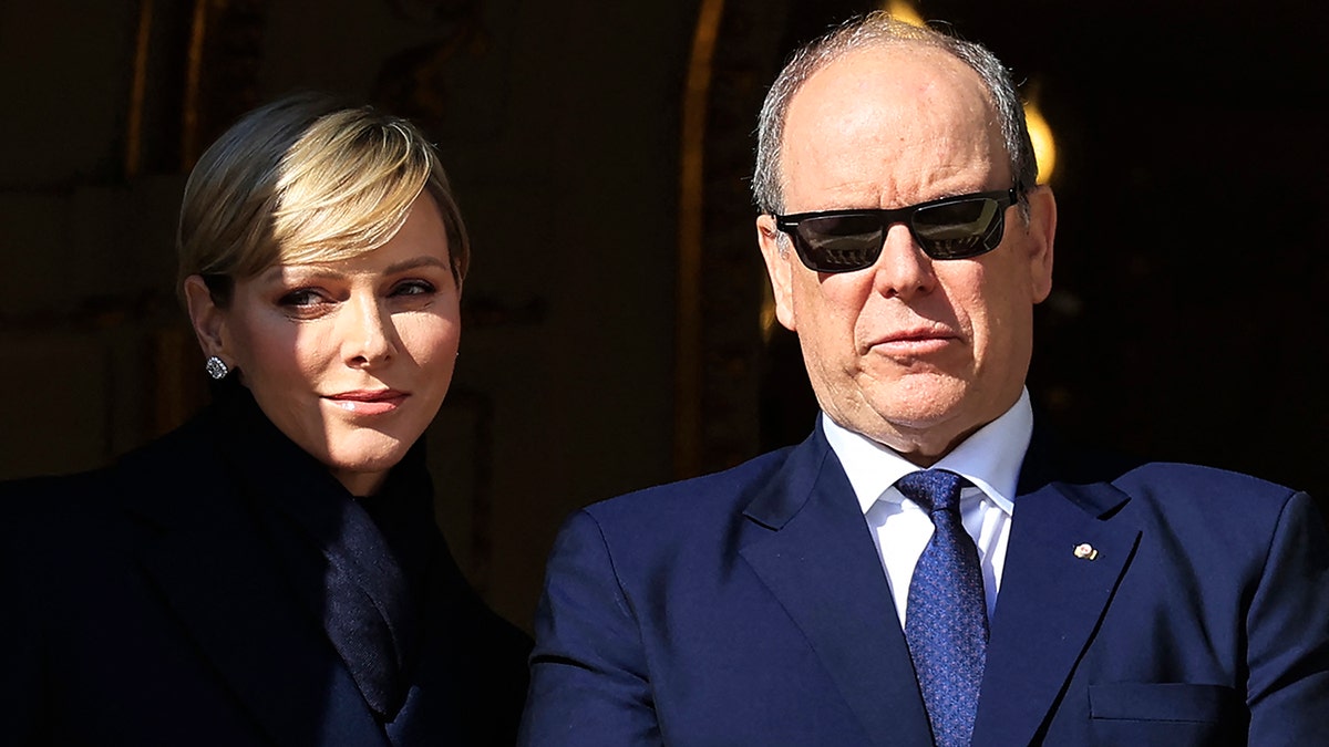 A close-up of Prince Albert wearing sunglasses next to Princess Charlene