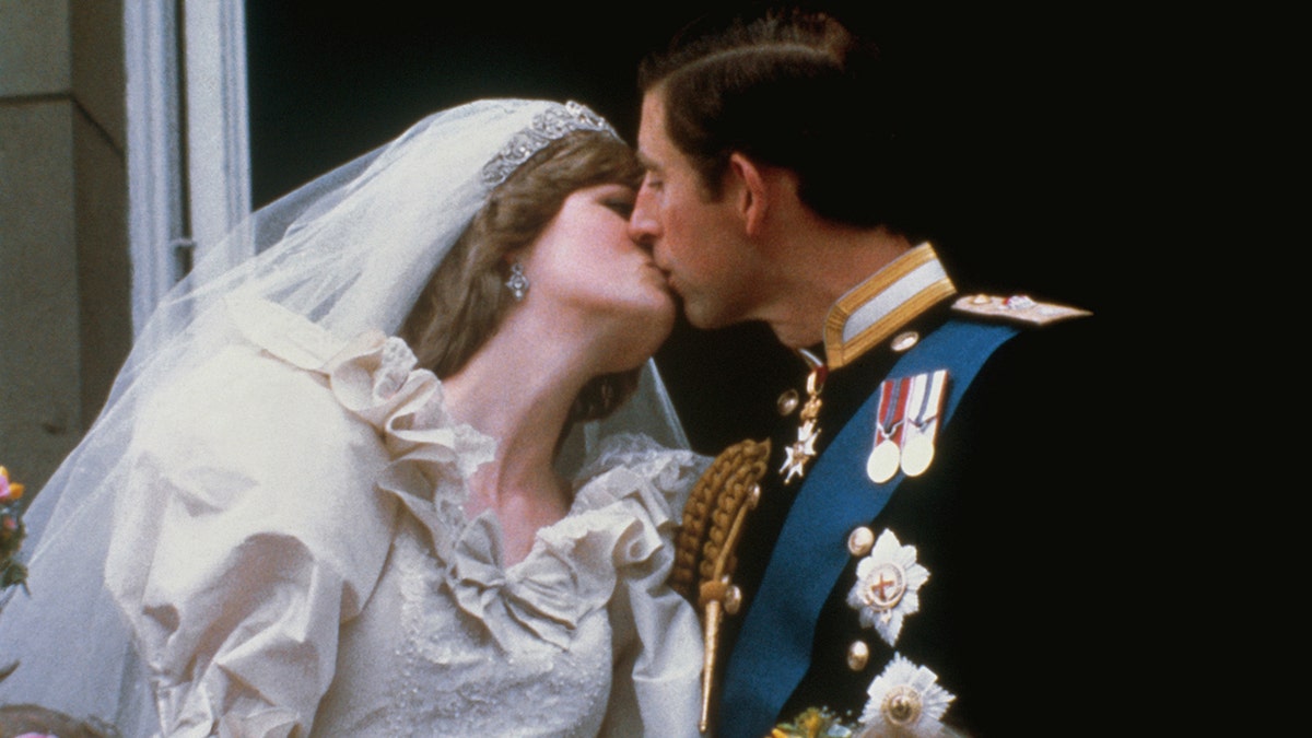Charles kissing Diana on their wedding day