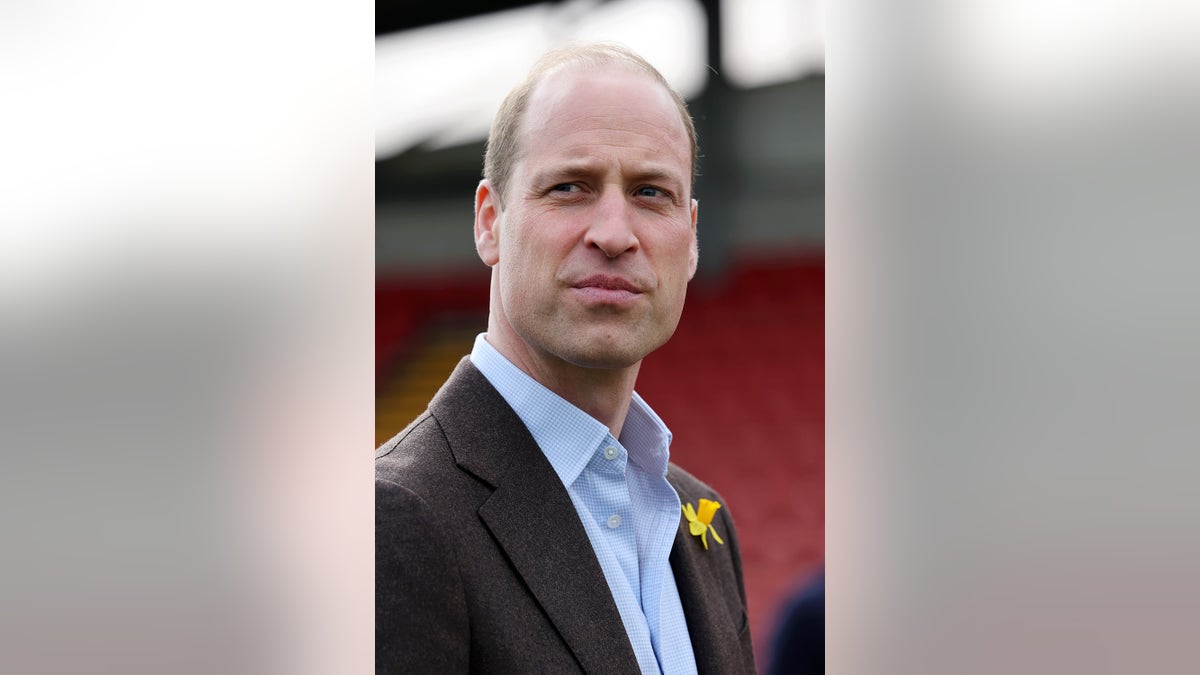 A close-up of Prince William with a daffodil