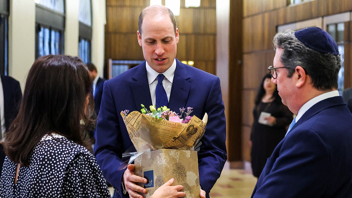 Prince William accepting flowers