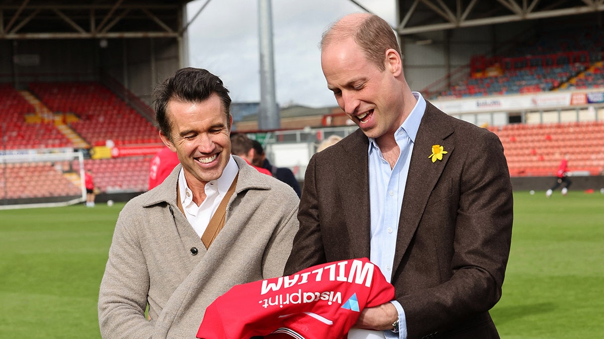 Prince William receives a red jersey with his name