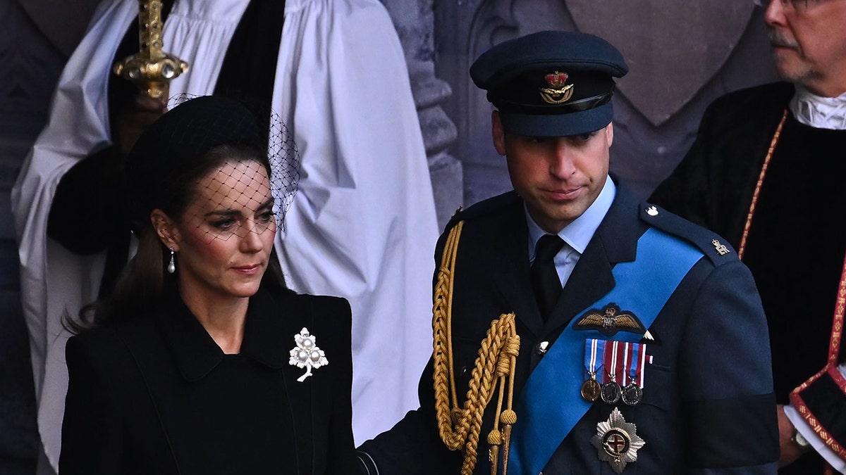 Kate Middleton and Prince William looking somber in formal wear