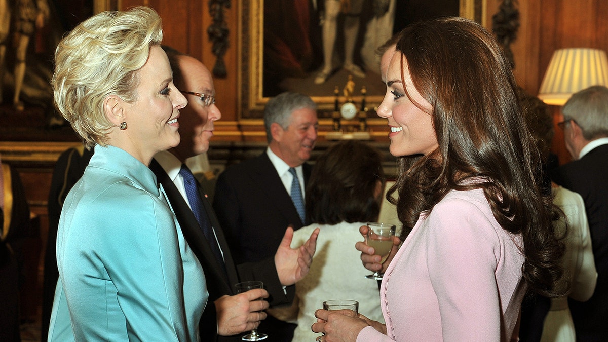 Princess Charlene speaking with Kate Middleton