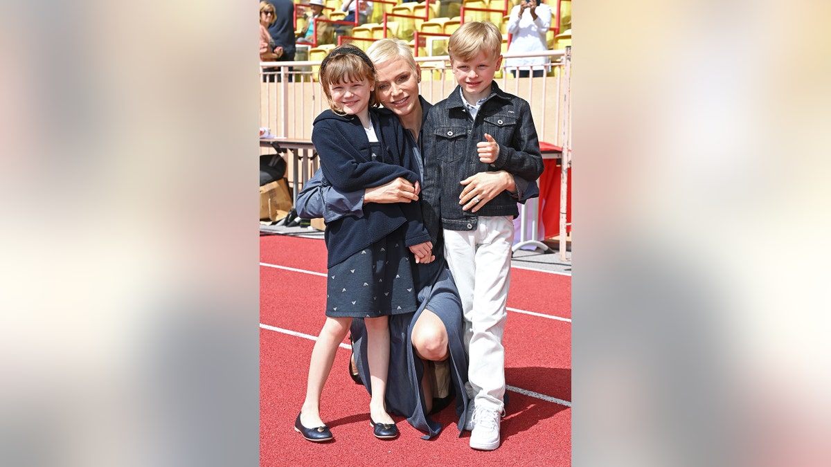 Princess Charlene of Monaco embracing her twins