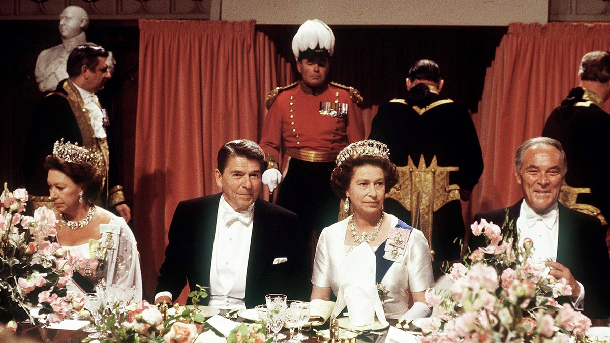 Queen Elizabeth II having a grand dinner with Ronald Reagan