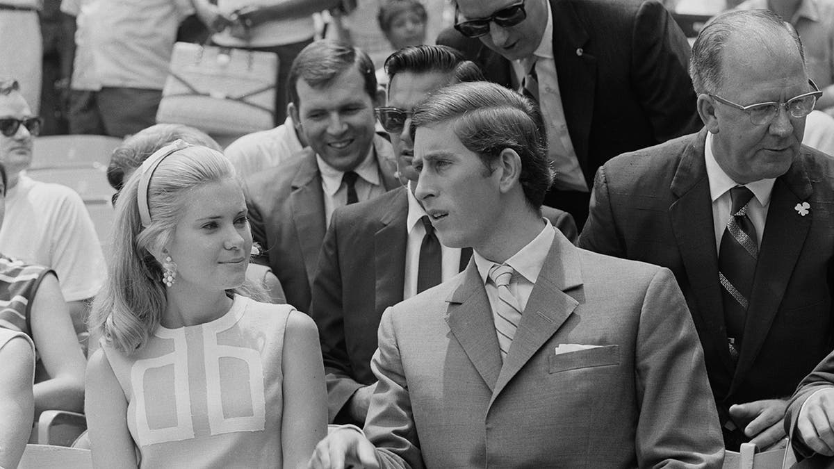 Prince Charles chatting with Tricia Nixon at a baseball game