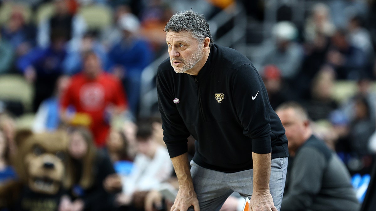 Greg Kampe looks on court with hands on knees