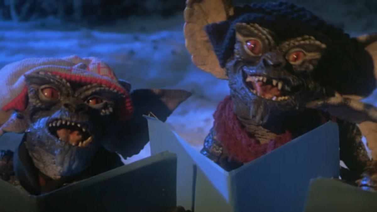 A scene from Gremlins with the Gremlins singing Christmas carols
