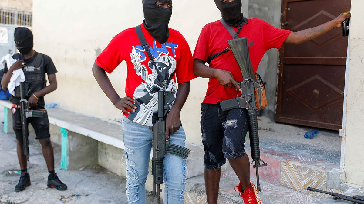 Haiti gang members standing with guns