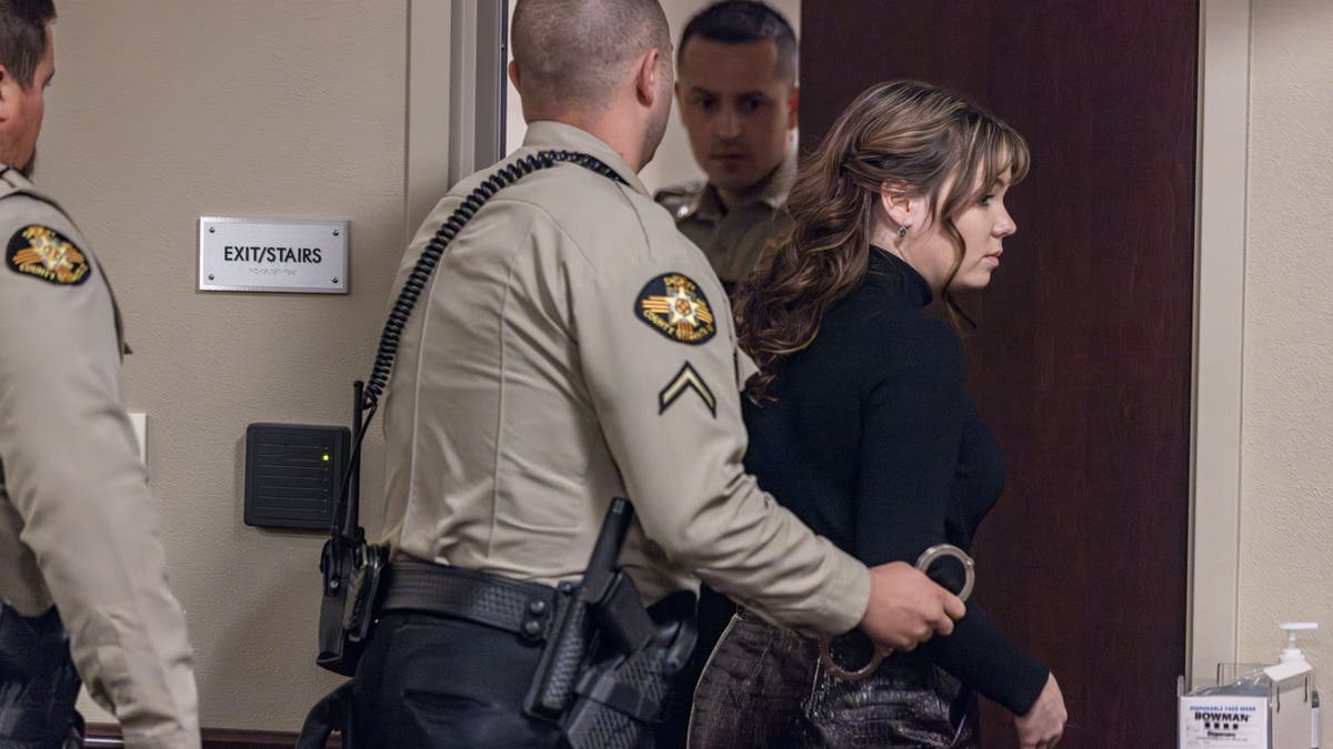 Hannah Gutierrez Reed being led out of a courtroom