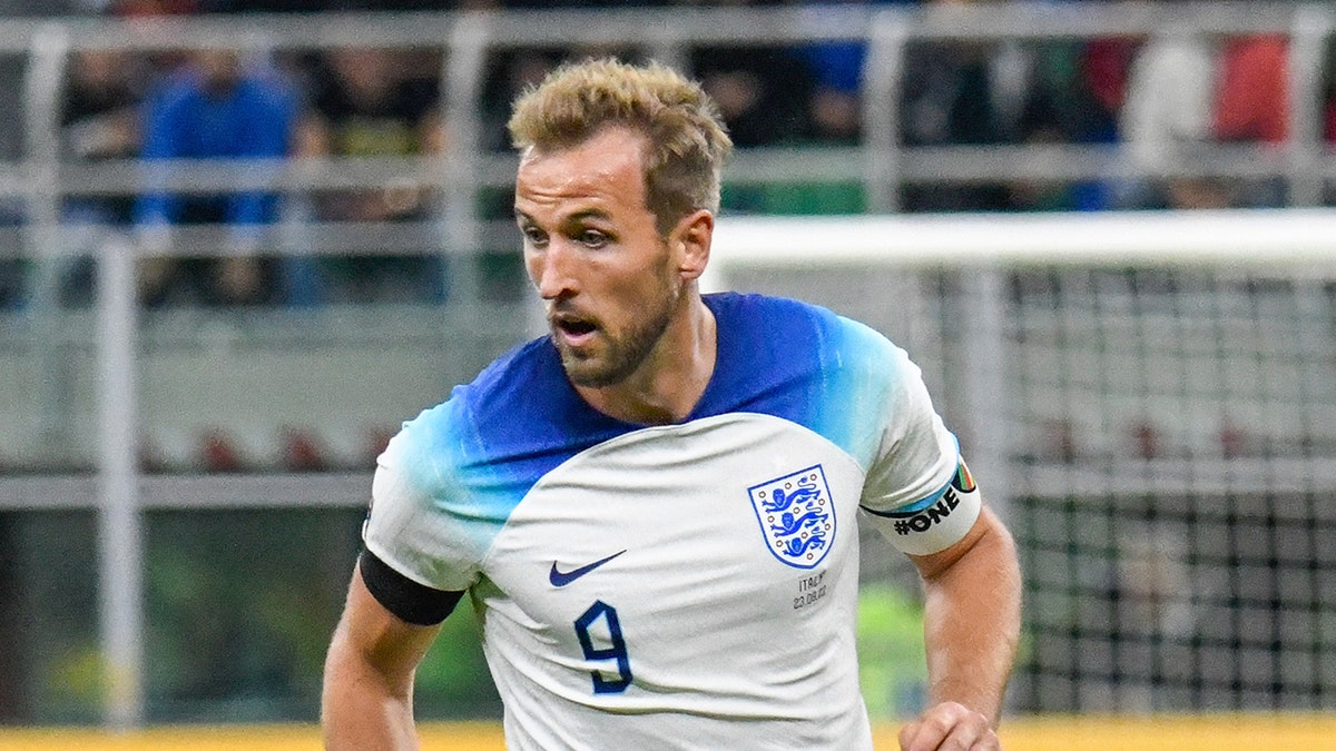 Harry Kane runs with soccer ball