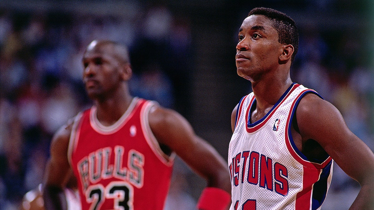 Isiah Thomas stands on the basketball court
