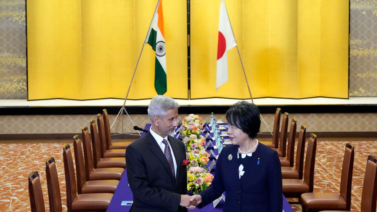 Indian Foreign Minister Subrahmanyam Jaishankar, left, and his Japanese counterpart, Yoko Kamikawa, shake hands