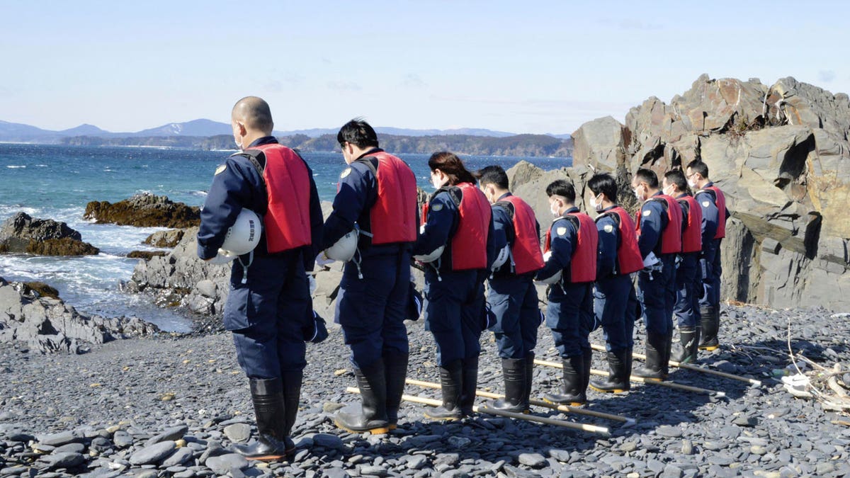 Japanese police officers search for missing persons