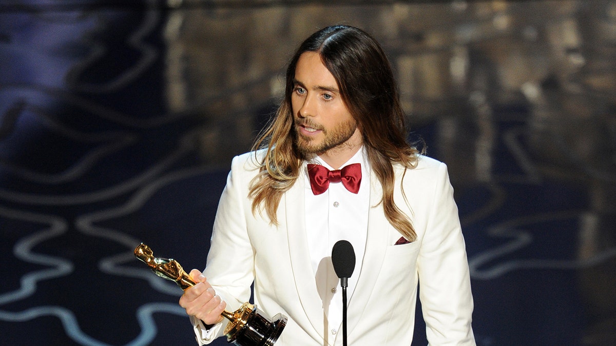 Jared Leto holding his Oscar on stage