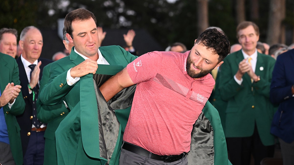 Scottie Scheffler puts green jacket on Jon Rahm