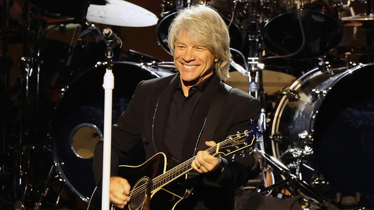 Singer Jon Bon Jovi plays the guitar on stage