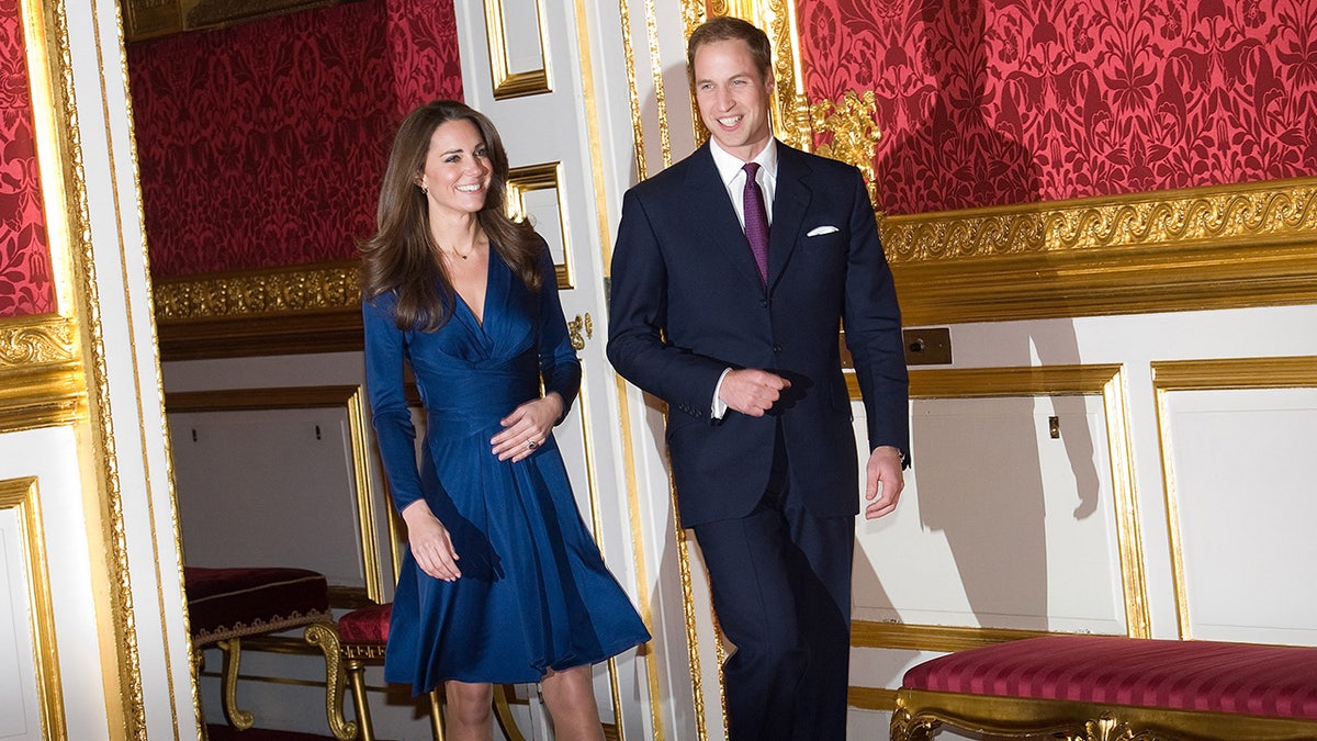 Kate Middleton and Prince William walk into a room at St James's Palace