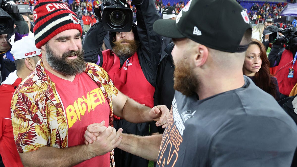 Jason and Travis Kelce clasp hands