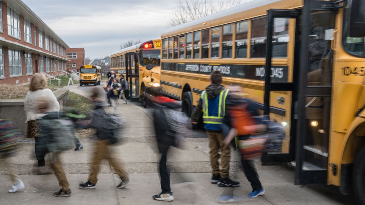 Students get off a school bus in Louisville, KY