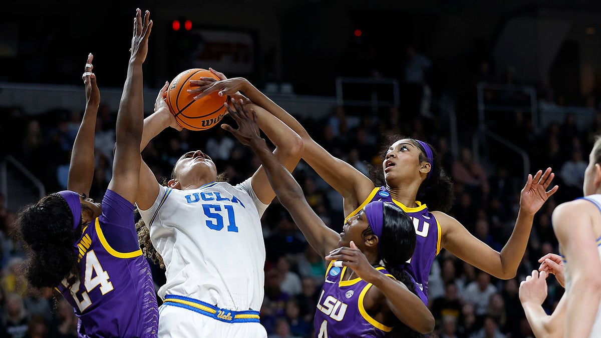 LSU Tigers players block a shot