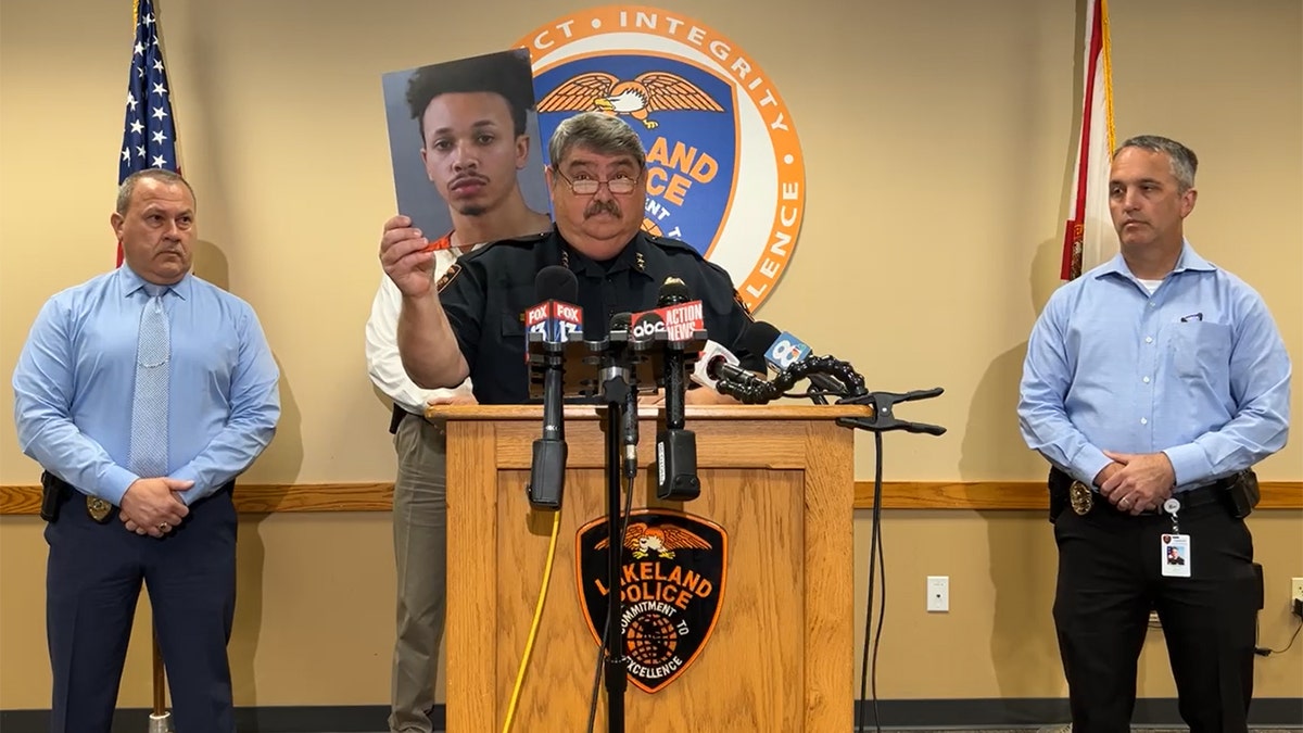 Lakeland Police Chief Sammy Taylor holds picture of Bobby Curry