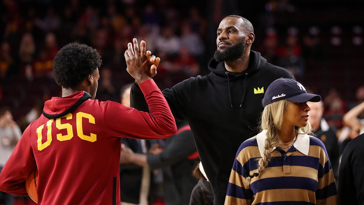 Bronny James shakes hands with his father, LeBron James