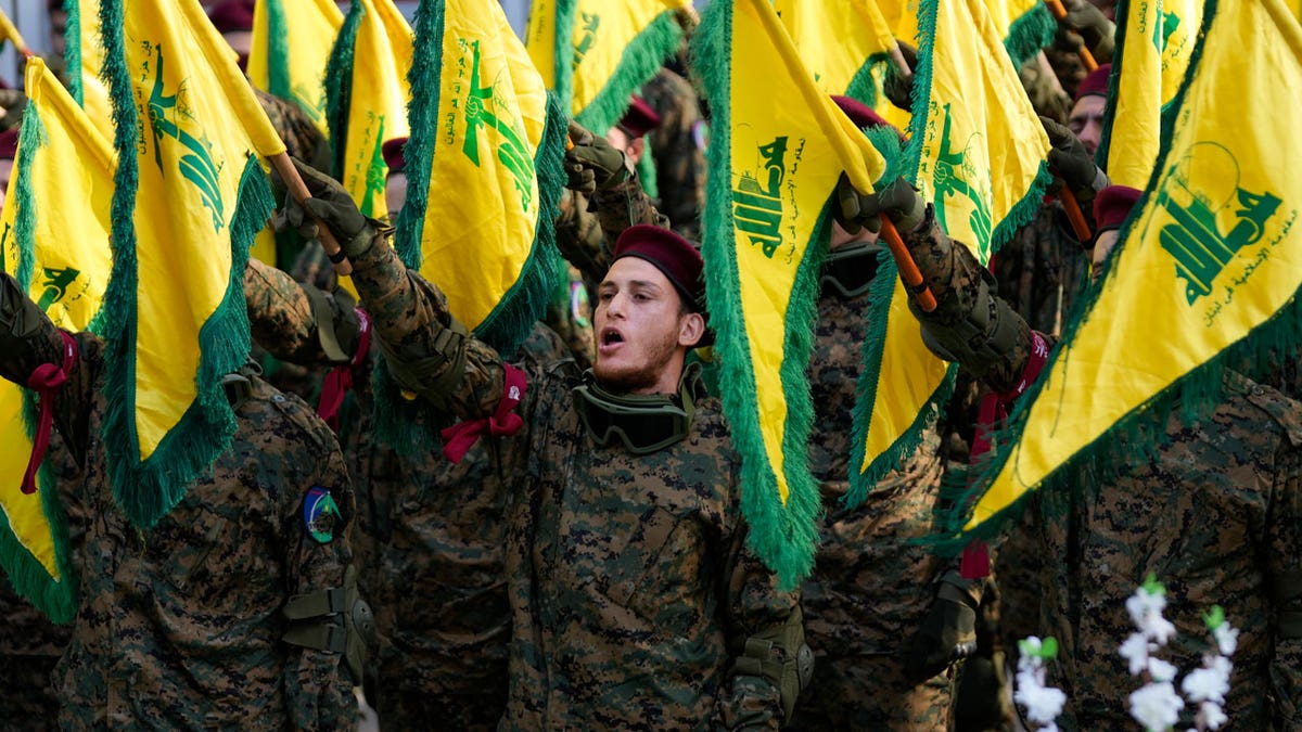 Hezbollah fighters attend their funeral of commander Wissam al-Tawil