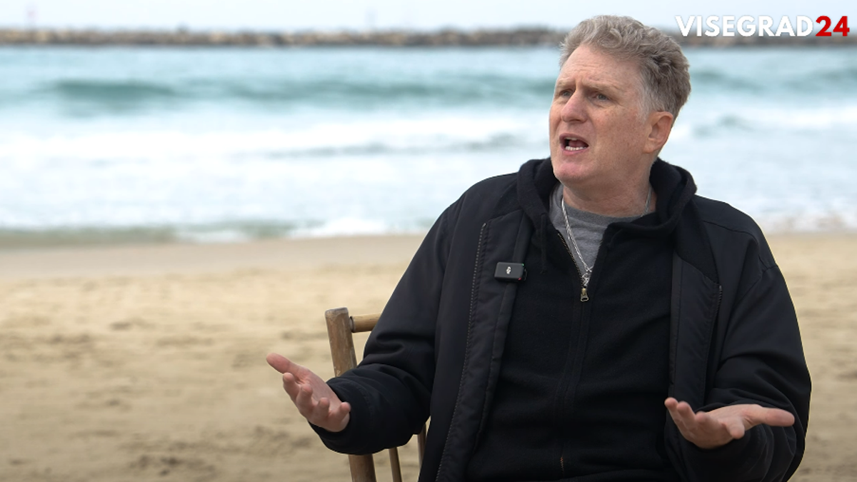 Michael Rapaport speaks on a beach