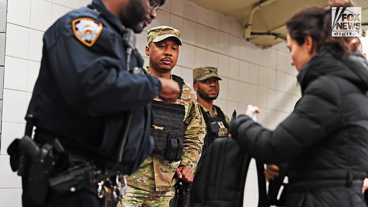 Members of the NYPD and National Guard conduct randomized bag searches in New York City’s subway system