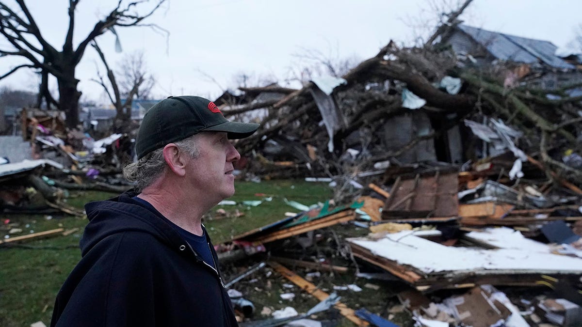 Ohio resident walks by storm damage