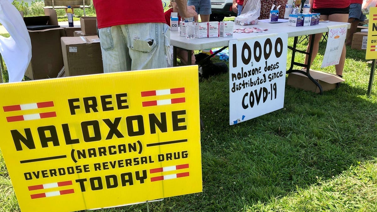 Signs are displayed at a tent during a health event in Charleston, West Virginia