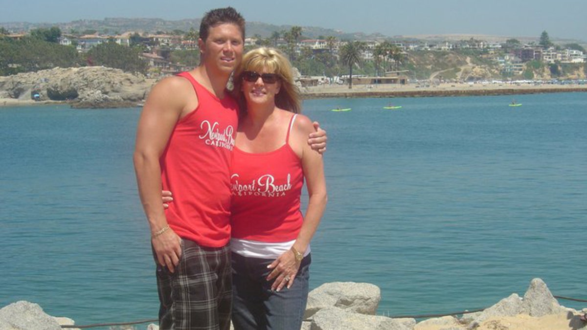 Cynthia Portaro embracing her son Michael in matching red tank tops
