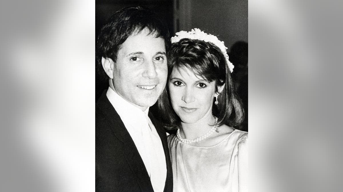 Black and white photo of Paul Simon and Carrie Fisher