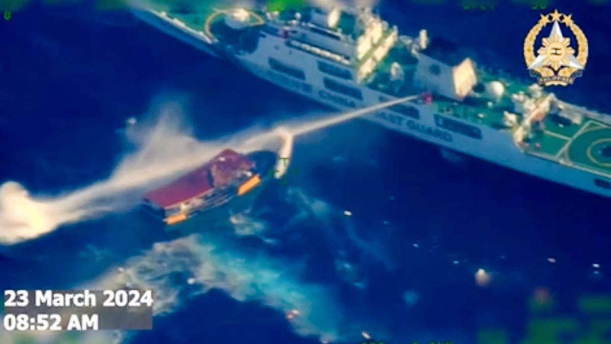 A Chinese coast guard ship uses water cannons on a Philippine resupply vessel