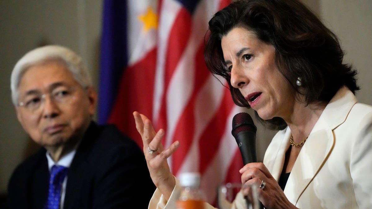 U.S. Commerce Secretary Gina Raimondo talks beside Philippine Trade and Industry Secretary Alfredo Pascual