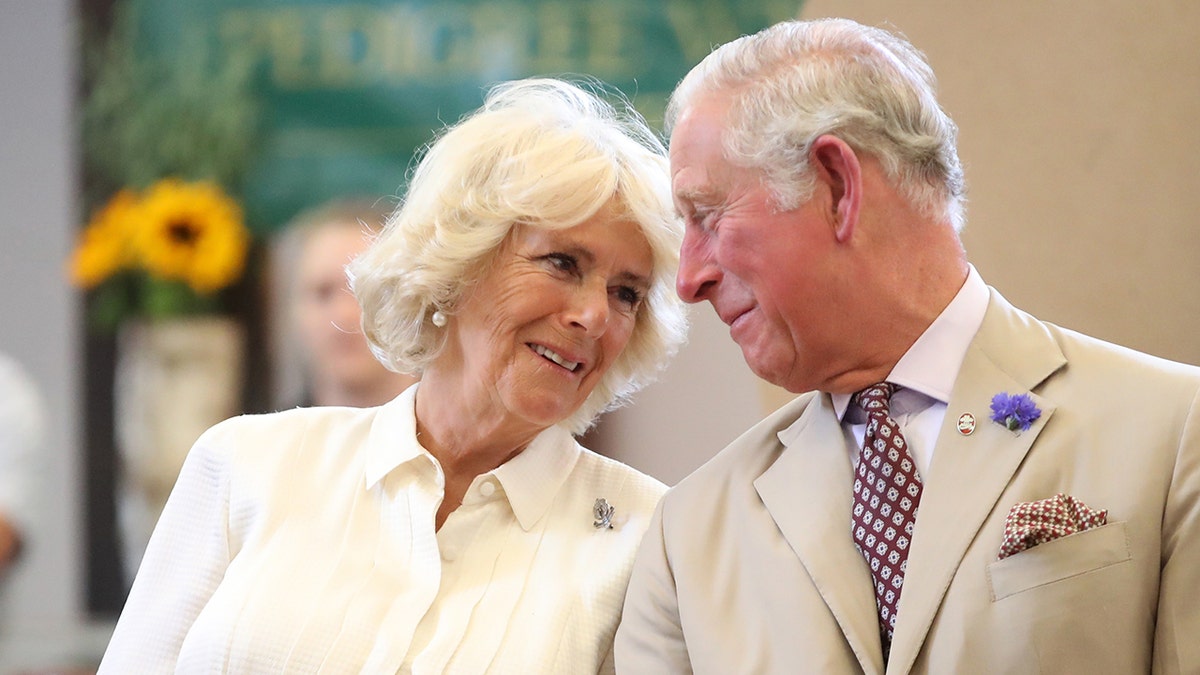 Queen Camilla and King Charles III share a look