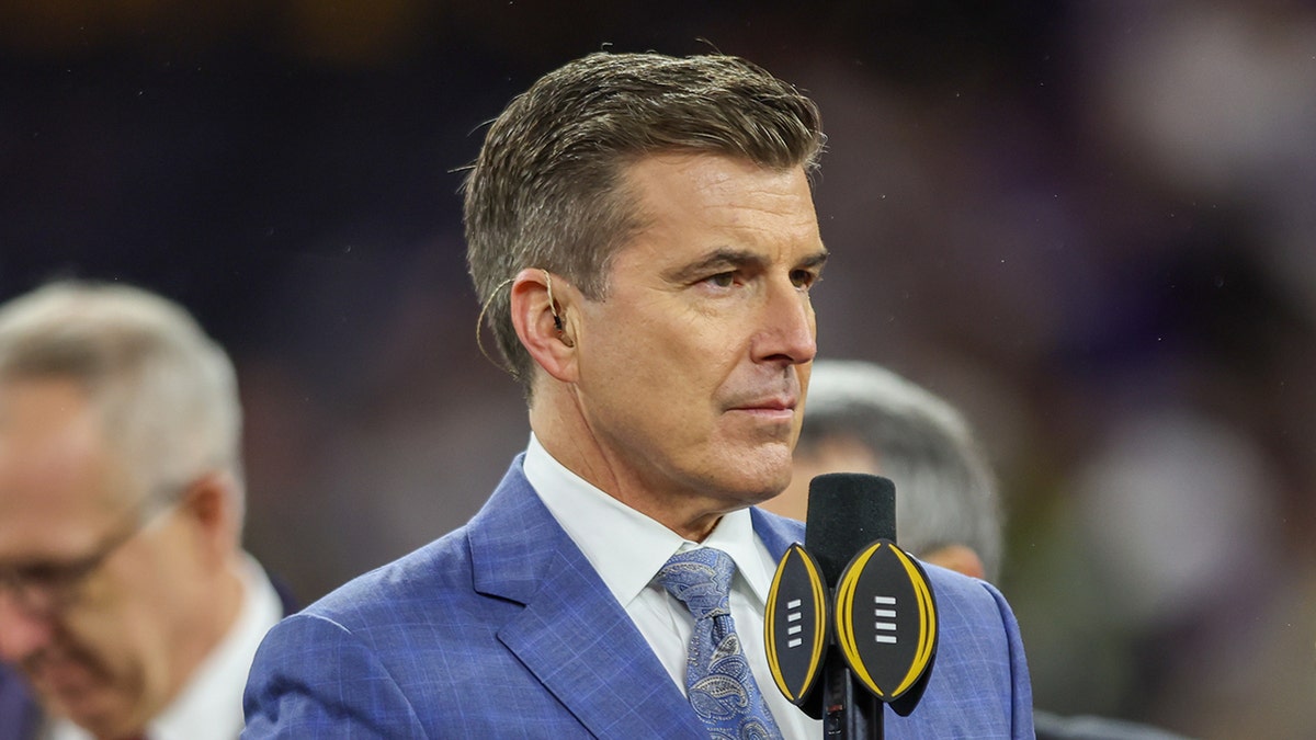 Rece Davis with microphone on field